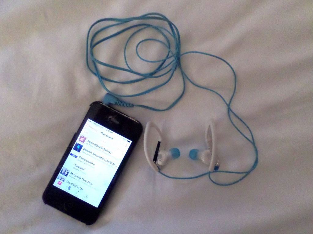 An iPhone and over-the-ear sport headphones