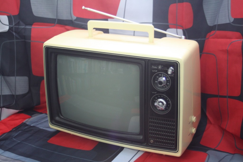 A 1970s style portable black and white television