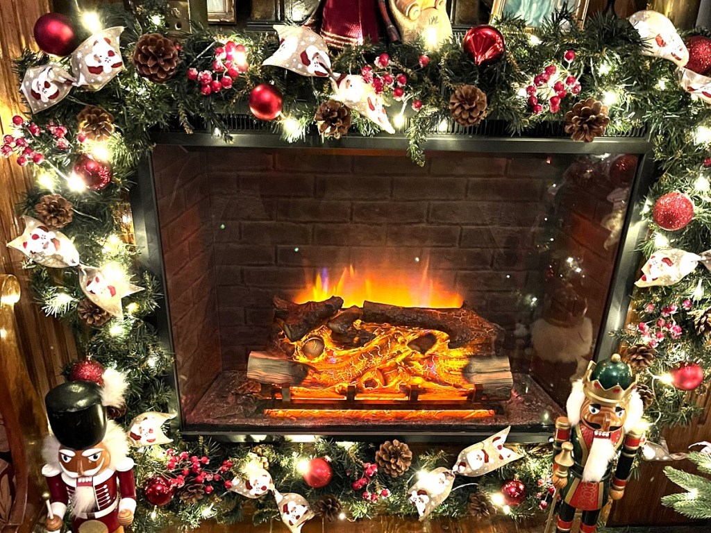 An electric fireplace decorated in bright colours for the Christmas holidays.
