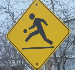 A street sign indicating "Children Playing"