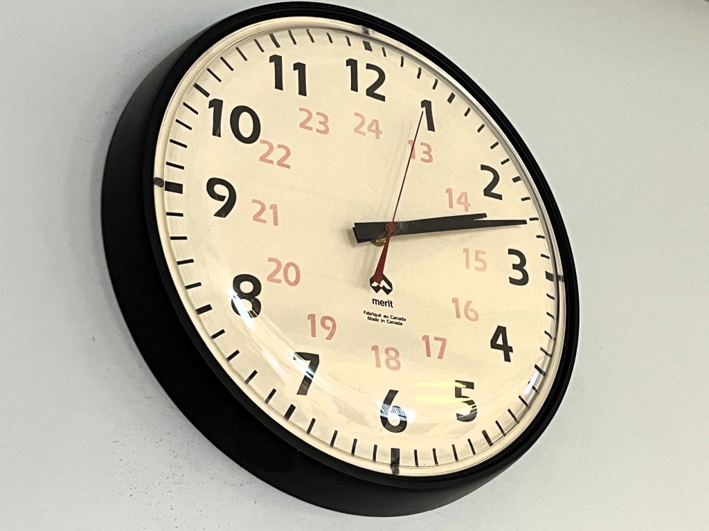 A wall clock showing the time as 2:12