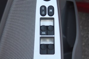 A car's window controls in the driver-side door