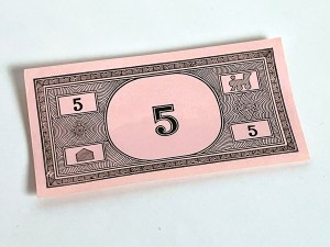 Play money in the denomination of five dollars