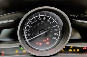 A car dashboard with several warning lights illuminated