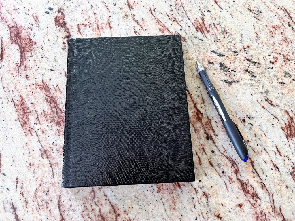 A journal and pen on a counter