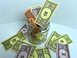 A swear jar fully of "money"