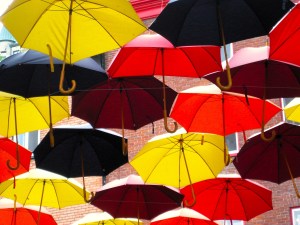 A multitude of colourful umbrellas hanging over the streets of Quebec City.