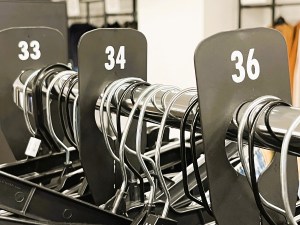A clothing rack with the sizes of the clothing prominently displayed. 