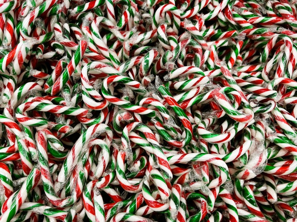 A close-up shot of candy canes in a bulk store's bin.
