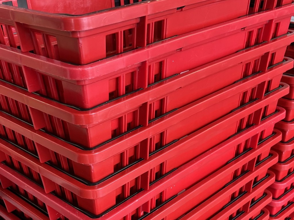 A stack of shopping baskets at the grocery store.