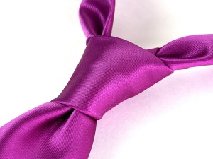 A bright pink tie in a half-Windsor knot.