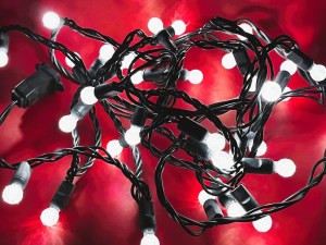 A closeup shot of a string of white Christmas lights.