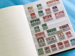 A photo of a page of my stamp collector's album, featuring vintage Canadian stamps.