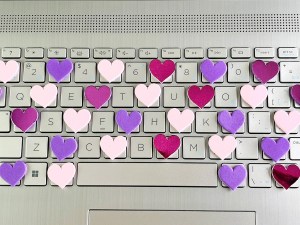 A keyboard from a notebook computer with hearts on the keys.
